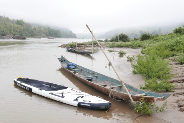 One of our boards tied up next to a local canoe (which was the inspiration for the trip)